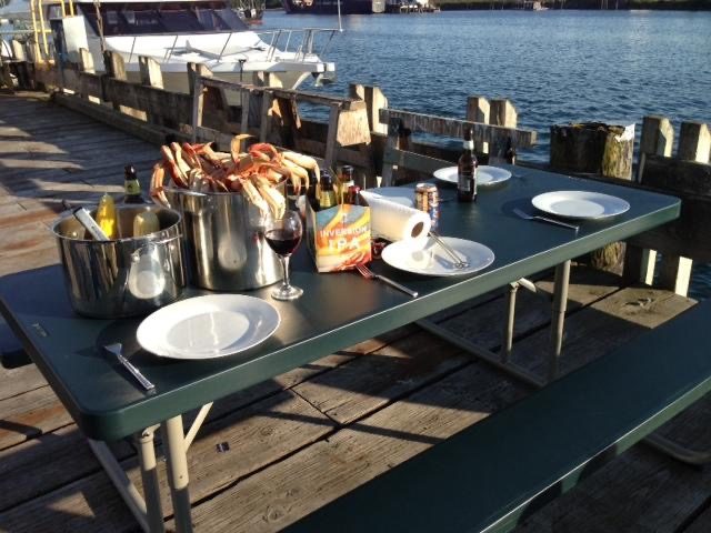 A crab dinner laid out on a table on the dock at Fisherman's Quay