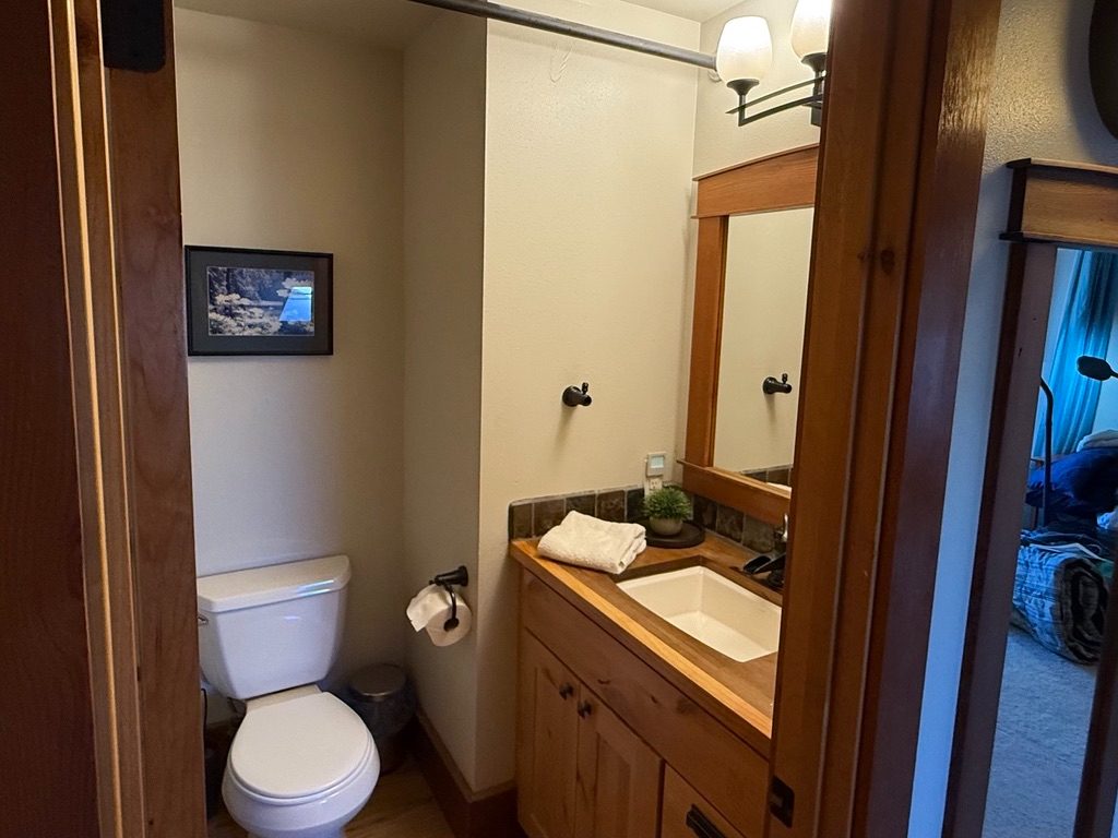 Bathroom in The Loft with a timber vanity, tile backsplash and mirror