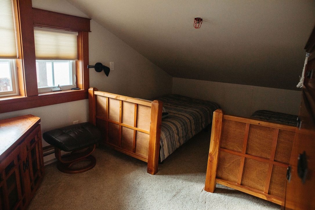 Bedroom in The Loft with two extra-long twin beds set under the sloped eave