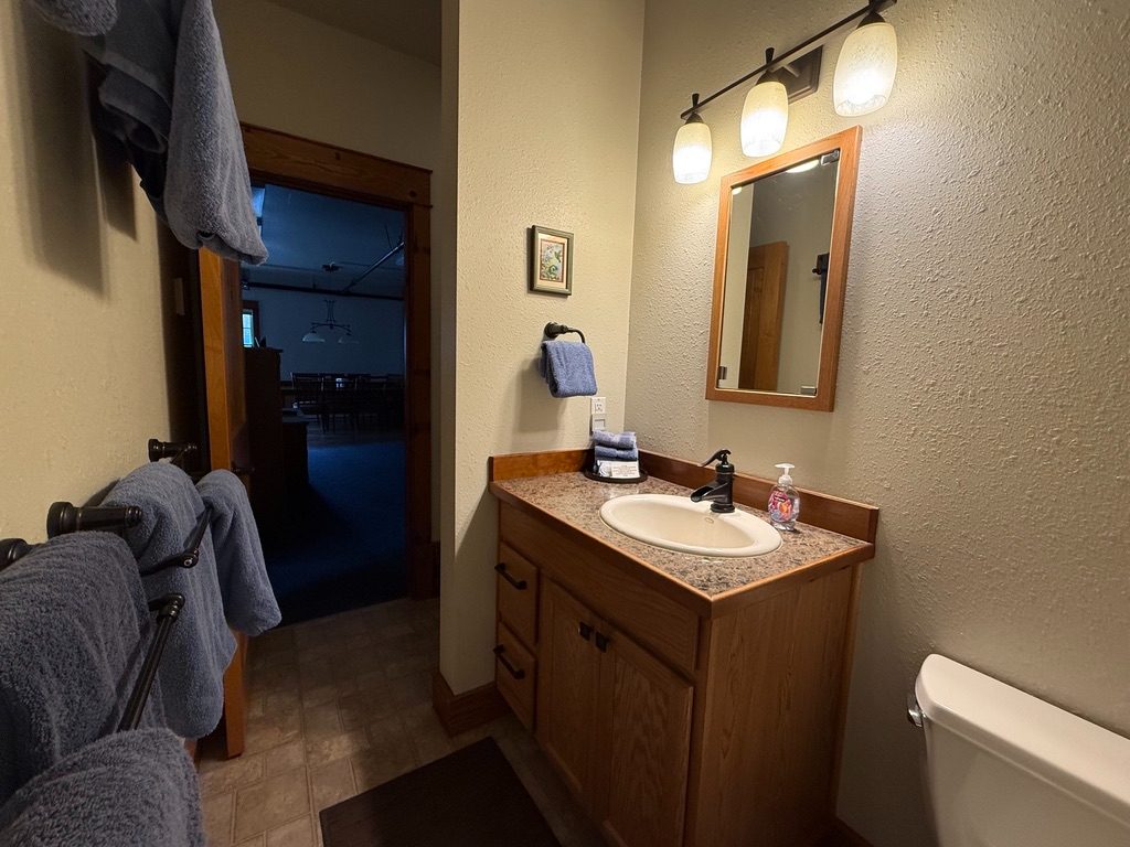 Bathroom in the North Bunkhouse with a vanity, mirror and towels