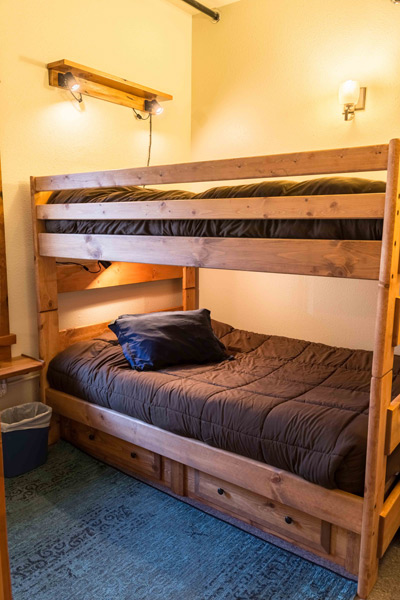 Solid timber bunk bed in the North Bunkhouse with drawers underneath and reading lights above
