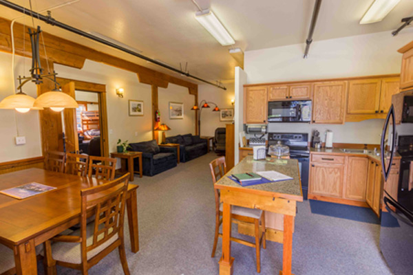 Full-sized kitchen in the North Bunkhouse with oak cabinets, electric range, microwave and a prep table