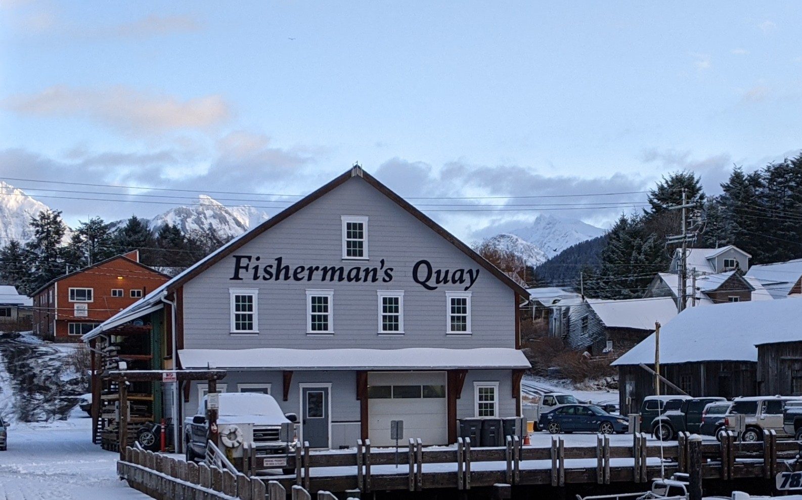The Fisherman's Quay building and dock under fresh snow on a winter morning