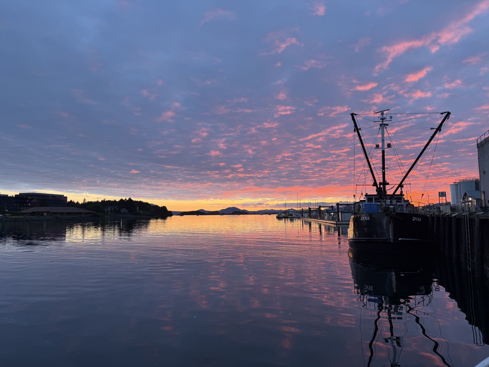 Sunset over Sitka Channel from the Fisherman's Quay dock, with a fishing boat moored alongside